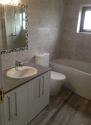 Fully fitted bathroom with shower bath